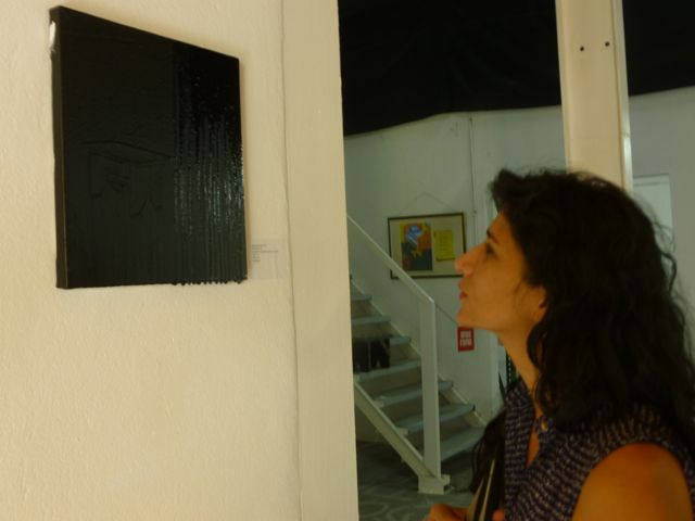Ivelisse in front of Sebastien Mehal's painting at T&T gallery, Guadeloupe. Mehal is a member of L'Artocarpe