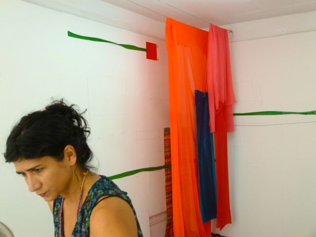 The artist Ivelisse Jimenez working on her piece at L'Artocarpe